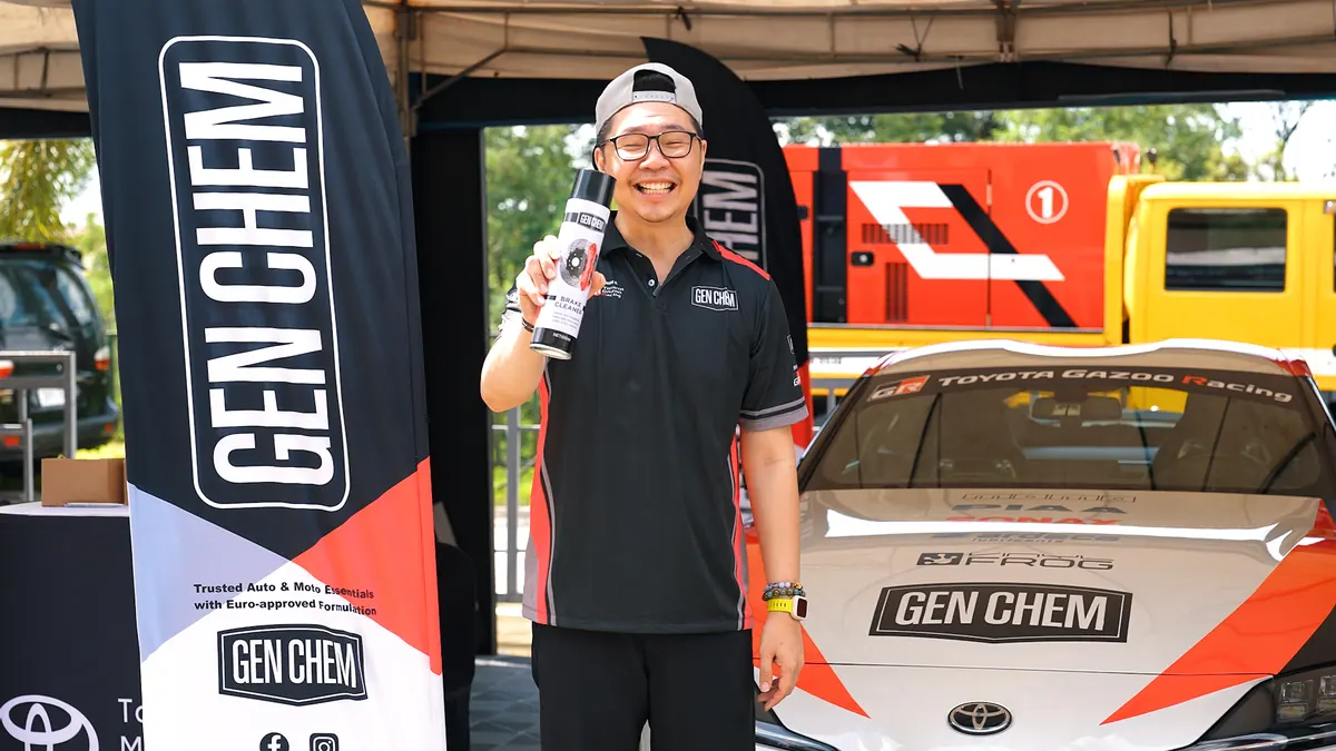 Event host beside a GEN CHEM-liveried Toyota GR Supra