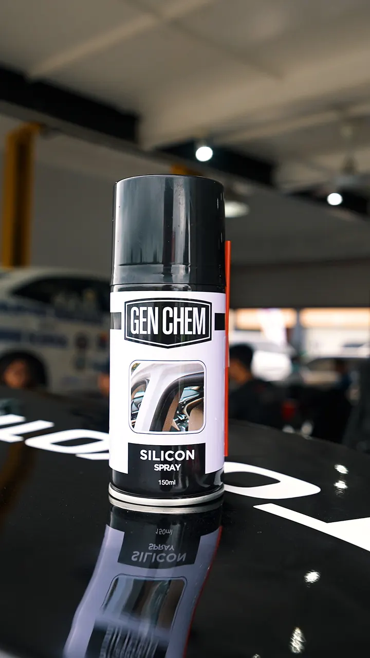 GEN CHEM silicone spray photographed beside a display car