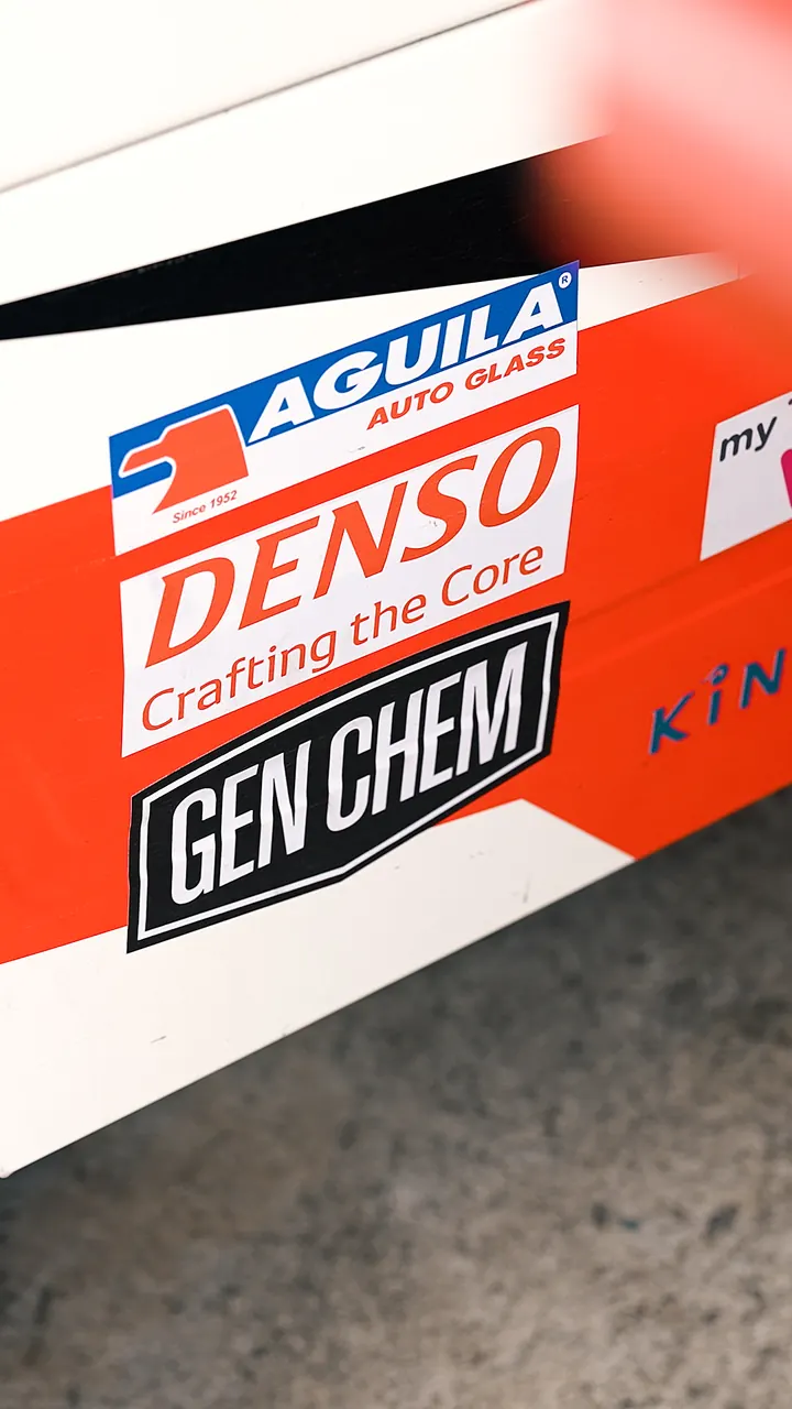 Close vertical view of GEN CHEM branding on race-car bodywork